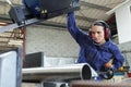 female worker cuts metal pipe Royalty Free Stock Photo