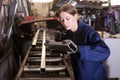 Female worker cuts metal profile pipe on a band saw Royalty Free Stock Photo