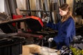 Female worker cuts metal profile pipe on a band saw Royalty Free Stock Photo