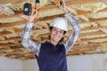 female worker drilling ceiling Royalty Free Stock Photo