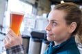 female worker examining glass beer Royalty Free Stock Photo