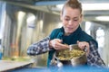 Female worker examining hops in bowl