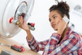 Female worker fixing boiler problem