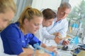 female worker fixing dentures in dental lab Royalty Free Stock Photo