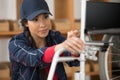 female worker fixing wheelchair Royalty Free Stock Photo