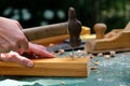 Female worker hammering a nail into wood plank. Woodworking concept Royalty Free Stock Photo