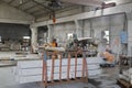 Female worker hoisting stone material in workroom Royalty Free Stock Photo