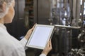 Female Worker Holding Digital Tablet at Food Factory Royalty Free Stock Photo