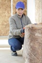 female worker at indoors wall insulation works Royalty Free Stock Photo