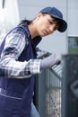 Female worker installing welded metal mesh fence Royalty Free Stock Photo