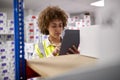 Female Worker In Logistics Distribution Warehouse Using Digital Tablet Royalty Free Stock Photo