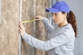female worker measuring walls Royalty Free Stock Photo