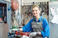 Female worker in metal workshop looking at camera Royalty Free Stock Photo
