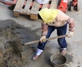 Female worker mixing cement