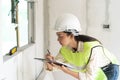 Female worker occupation. Woman inspector / architect checking interior material process in house reconstruction project Royalty Free Stock Photo