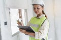 Female worker occupation. Woman inspector / architect checking interior material process in house reconstruction project Royalty Free Stock Photo