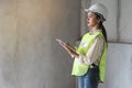 Female worker occupation. Woman inspector / architect checking interior material process in house reconstruction project