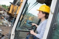 Female worker operating forklift truck in shipping yard Royalty Free Stock Photo