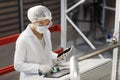 Female Worker Operating Machines at Pharmaceutical Factory Royalty Free Stock Photo