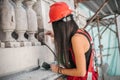 Female worker plastering old building wall using cement plaster mix Royalty Free Stock Photo