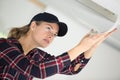 female worker repairing air conditioner Royalty Free Stock Photo