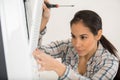 female worker repairing air conditioner with screwdriver Royalty Free Stock Photo