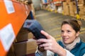 Female worker scanning bar-code packages Royalty Free Stock Photo