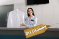 Worker with shirt at modern dry-cleaner`s Royalty Free Stock Photo