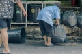 Female worker sort the garbage and packed in black bags Royalty Free Stock Photo