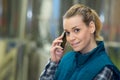 female worker speaking on mobile phone in industrial area Royalty Free Stock Photo