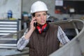 female worker speaking on mobile phone in industrial area Royalty Free Stock Photo