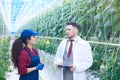 Female Worker Talking to Scientist in Modern Plantation