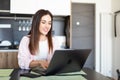 Female worker texting using laptop and internet, working online. Freelancer typing at home office, workplace Royalty Free Stock Photo