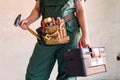 Female worker with tool kit and gavel Royalty Free Stock Photo