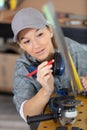 female worker using angle grinder in workshop Royalty Free Stock Photo