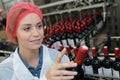 Female worker using machine to work at wine factory Royalty Free Stock Photo