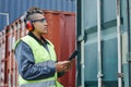 Female worker wearing ear protection at shipping docks Royalty Free Stock Photo