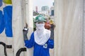 female worker in working dress poses for a portrait in safety clothes at the construction site in Bangkok