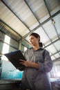 Female worker writing on clipboard in olive factory Royalty Free Stock Photo