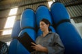 Female worker writing on clipboard in olive factory Royalty Free Stock Photo