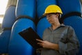 Female worker writing on clipboard in olive factory Royalty Free Stock Photo