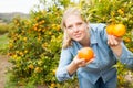 Female workers picking mandarins in box