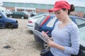 Female working on car scrap yard Royalty Free Stock Photo
