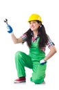 Female workman in green overalls holding key