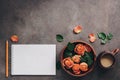 Female workspace with blank notepad, cup of coffee,ceramic bowl with flowers of coral roses and pencil. Top view, flat lay Royalty Free Stock Photo