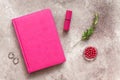 Female workspace, home office. Pink notepad, cosmetics, bijouterie on a beige vintage background. Modern blogger still life. Top