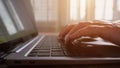 Female wrinkled fingers touch black keys of laptop keyboard Royalty Free Stock Photo