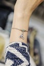 Female wrist wearing tiny jewelry bracelet