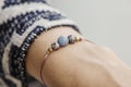 Female wrist wearing tiny jewelry bracelet