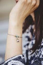 Female wrist wearing tiny jewelry bracelet